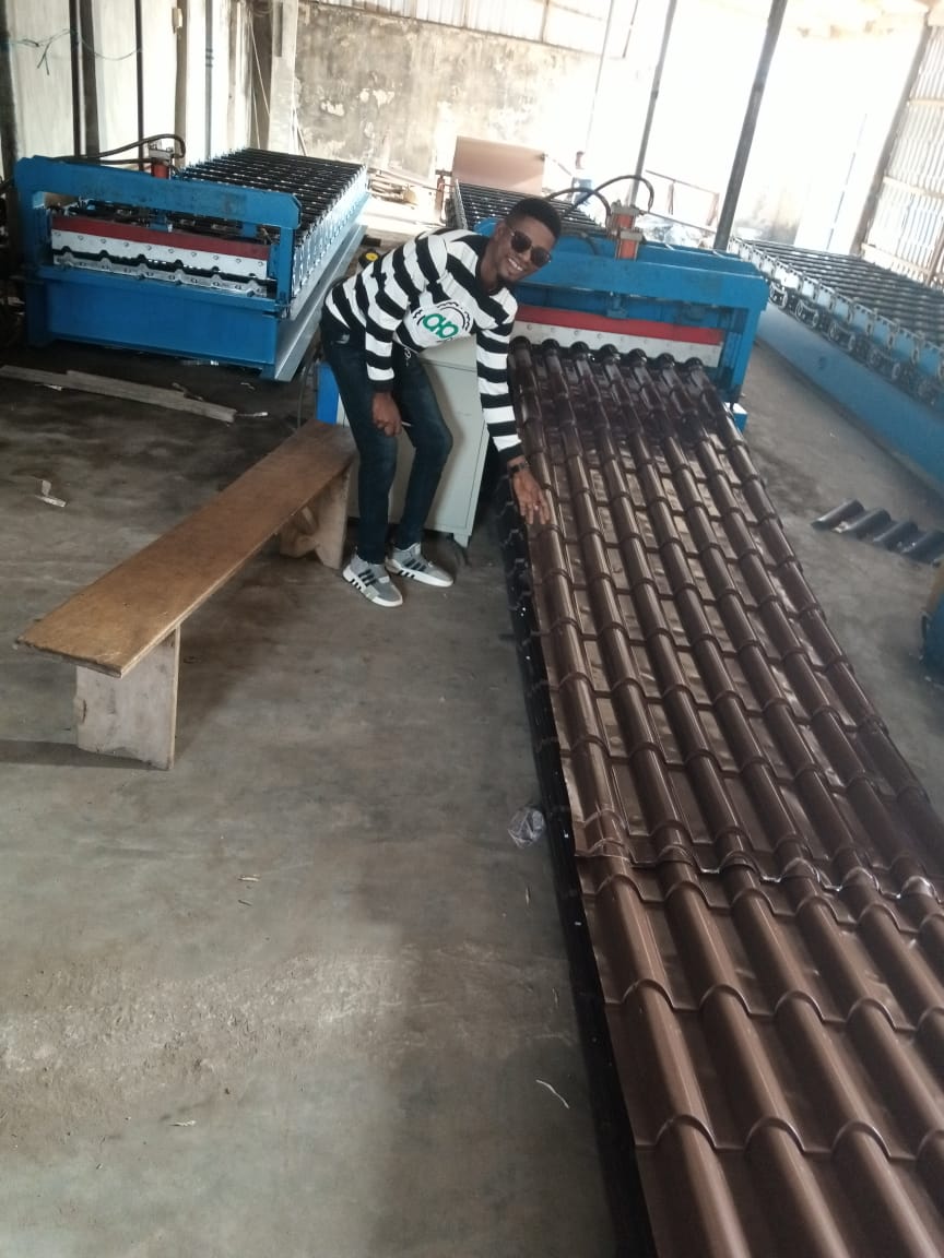 Roofwell installation crew laying stone-coated tiles on a residential roof structure